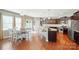 Spacious kitchen with stainless appliances, dark cabinets, large island, and adjacent dining area at 9301 Swimming Dr, Harrisburg, NC 28075