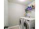 Bright laundry room featuring a washer, dryer, and shelving for storage at 9301 Swimming Dr, Harrisburg, NC 28075