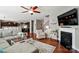 Open-concept living room includes hardwood floors, fireplace, and an adjacent eat-in kitchen at 9301 Swimming Dr, Harrisburg, NC 28075