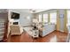 Inviting living room with hardwood floors, a cozy fireplace, and plenty of natural light offers a comfortable and stylish space at 9301 Swimming Dr, Harrisburg, NC 28075