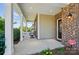 Side porch with seating, perfect for relaxing and enjoying the outdoor scenery and a view of the front lawn at 9301 Swimming Dr, Harrisburg, NC 28075