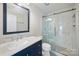 Beautiful bathroom featuring a modern vanity with marble counters and a glass door shower at 9647 Laurie Nw Ave, Concord, NC 28027