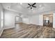 Large bedroom with tray ceilings, ceiling fan and wood flooring at 9647 Laurie Nw Ave, Concord, NC 28027