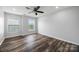This bedroom has wood floors, a ceiling fan, and large windows for lots of natural light at 9647 Laurie Nw Ave, Concord, NC 28027