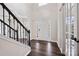 Bright foyer with hardwood floors, staircase with black iron spindles, and elegant front door at 9647 Laurie Nw Ave, Concord, NC 28027