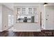 Modern kitchen with white cabinetry, stainless steel appliances, granite counters, and stylish glass-front display cabinets at 9647 Laurie Nw Ave, Concord, NC 28027