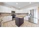 Bright kitchen with white cabinetry, stainless steel appliances, island, and tile backsplash at 9647 Laurie Nw Ave, Concord, NC 28027