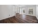 Open living room featuring hardwood floors, French doors, and natural light from multiple windows at 9647 Laurie Nw Ave, Concord, NC 28027