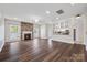 Open-concept living room with fireplace, hardwood floors, and seamless flow to the kitchen area at 9647 Laurie Nw Ave, Concord, NC 28027