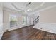 Elegant living room with hardwood floors, wainscoting, large windows, and ample natural light at 9647 Laurie Nw Ave, Concord, NC 28027