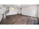 Bright living room featuring hardwood floors, with staircase access to the upper level, and modern fixtures at 9647 Laurie Nw Ave, Concord, NC 28027