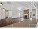 Spacious living room with fireplace, hardwood floors, and seamless flow to the kitchen with breakfast bar at 9647 Laurie Nw Ave, Concord, NC 28027