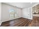 Office space with hardwood floors, a window with blinds, natural light, and a modern glass door entry at 9647 Laurie Nw Ave, Concord, NC 28027
