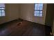 Aged bedroom featuring hardwood floors, neutral walls, and two windows with natural light at 1015 Frederick St, Shelby, NC 28150