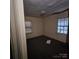 Bedroom featuring dark hardwood floors, neutral walls, and two windows with natural light at 1015 Frederick St, Shelby, NC 28150