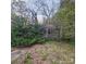Aged exterior obscured by overgrown landscaping at 1015 Frederick St, Shelby, NC 28150