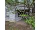 Distressed exterior with peeling paint, overgrown landscaping, and a covered porch at 1015 Frederick St, Shelby, NC 28150