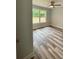 This bedroom features hardwood floors, neutral walls, a ceiling fan, and a window letting in natural light at 1050 Beaten Path Rd, China Grove, NC 28023