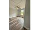 This bedroom features hardwood floors, neutral walls, a ceiling fan, and a window letting in natural light at 1050 Beaten Path Rd, China Grove, NC 28023