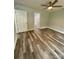 This bedroom features hardwood floors, neutral walls, and a ceiling fan, and doorway to the bathroom at 1050 Beaten Path Rd, China Grove, NC 28023