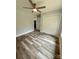 This bedroom features hardwood floors, neutral walls, a ceiling fan, and a closet at 1050 Beaten Path Rd, China Grove, NC 28023