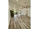Expansive living room featuring modern floors, a large fan, and view of the updated kitchen at 1050 Beaten Path Rd, China Grove, NC 28023