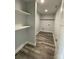 Functional pantry with ample shelving and modern flooring, offering efficient storage solutions at 1050 Beaten Path Rd, China Grove, NC 28023