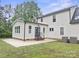 Home exterior with spacious backyard, patio, and an addition with many windows at 10749 Kingsview Dr, Davidson, NC 28036