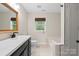Clean bathroom featuring modern fixtures, tile accents, and a window for natural light at 10749 Kingsview Dr, Davidson, NC 28036