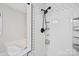 Shower with modern fixtures, tile accents, and built-in shelving at 10749 Kingsview Dr, Davidson, NC 28036