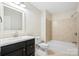 Neutral bathroom with white countertop and vanity, tiled shower, and matching tile flooring at 10749 Kingsview Dr, Davidson, NC 28036