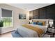 Staged bedroom with unique wall design, hardwood floors, and a sunlit window at 10749 Kingsview Dr, Davidson, NC 28036