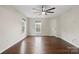 Bright bedroom features hardwood floors, a ceiling fan, and two windows providing ample natural light at 10749 Kingsview Dr, Davidson, NC 28036