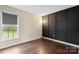 Open staged bedroom featuring unique wall design, hardwood floors, and light at 10749 Kingsview Dr, Davidson, NC 28036