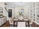 Elegant dining room with a modern table, comfortable seating, and built-in shelving at 10749 Kingsview Dr, Davidson, NC 28036