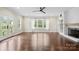 Bright living room with a fireplace, large windows, and hardwood flooring throughout at 10749 Kingsview Dr, Davidson, NC 28036