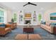 Bright living room with a fireplace, stylish furniture, and large windows at 10749 Kingsview Dr, Davidson, NC 28036