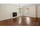 Inviting living room featuring hardwood floors, a charming fireplace, and natural light at 10749 Kingsview Dr, Davidson, NC 28036