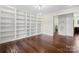 Spacious living room featuring hardwood floors, built-in shelving, and a bright, open layout at 10749 Kingsview Dr, Davidson, NC 28036