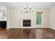Spacious living room with hardwood floors, a cozy fireplace, and a bright window view at 10749 Kingsview Dr, Davidson, NC 28036