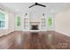 Bright living room boasts hardwood floors, fireplace with built-ins, and natural light at 10749 Kingsview Dr, Davidson, NC 28036