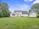 Property with large, green yard, outbuilding, and a home addition with multiple windows at 10749 Kingsview Dr, Davidson, NC 28036
