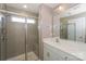 Modern bathroom featuring tiled shower with glass door, a large mirror, and white marble countertop at 110 Synandra Dr # B, Mooresville, NC 28117