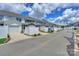 Street view of townhomes featuring garages, white fences, and landscaping at 110 Synandra Dr # B, Mooresville, NC 28117