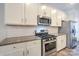 Modern kitchen design featuring stainless steel appliances, white cabinets, and granite countertops at 110 Synandra Dr # B, Mooresville, NC 28117