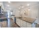 Bright kitchen features an island with granite countertops, stainless steel appliances, and wood floors at 110 Synandra Dr # B, Mooresville, NC 28117