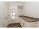 Eat-in kitchen area with granite counters, white cabinets, and door leading to outdoor patio at 110 Synandra Dr # B, Mooresville, NC 28117