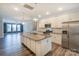 Open kitchen with stainless steel appliances, granite countertops, kitchen island, and modern lighting fixtures at 110 Synandra Dr # B, Mooresville, NC 28117