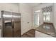 Eat-in kitchen area featuring granite countertops, white cabinets, and stainless steel refrigerator at 110 Synandra Dr # B, Mooresville, NC 28117