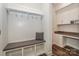 Mudroom with coat hooks, bench seating, and built-in desk area with granite countertop at 110 Synandra Dr # B, Mooresville, NC 28117
